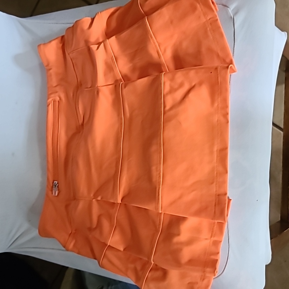 Womens tennis skirt. With shorts-liner. Size XS. Orange. NWOT